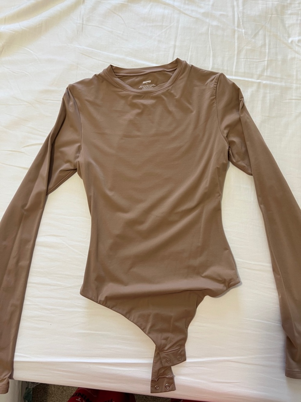 SKIMS Long Sleeve Crewneck Bodysuit in Brown